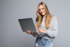 https://oxford-debrecen.hu/wp-content/uploads/2025/11/young-happy-smiling-woman-casual-clothes-holding-laptop-sending-email-her-best-friend-isolated-gray-background.jpg